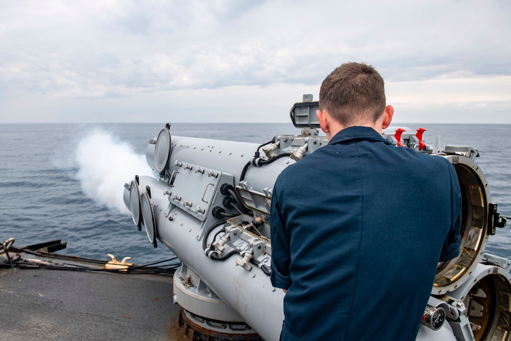 Gunner’s Mate 3rd Class Sebastian Demarais, from Portsmouth, Va., fires an air slug from a Mark-32 surface vessel torpedo tube