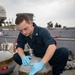 Gunner’s Mate 3rd Class Sebastian Demarais, from Portsmouth, Va., lubricates a Mark-32 surface vessel torpedo tube air flask