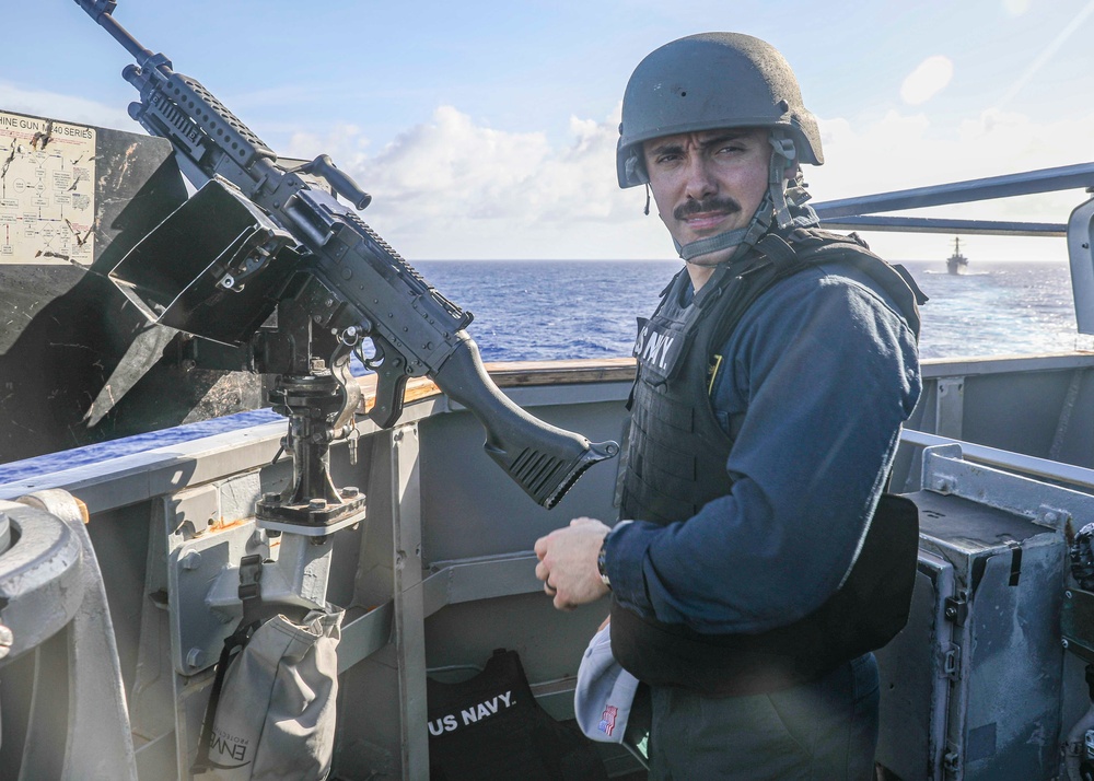 Officer Mans Machine Gun Aboard USS Higgins