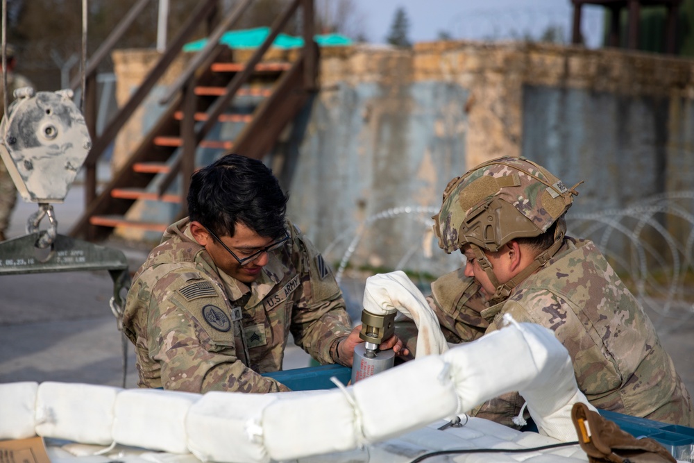 Soldiers with 10th Brigade Engineer Battalion, 1st Armored Brigade Combat Team, 3rd Infantry Division prepare equipment for the Mine Clearing Line Charge (MiC-LiC)