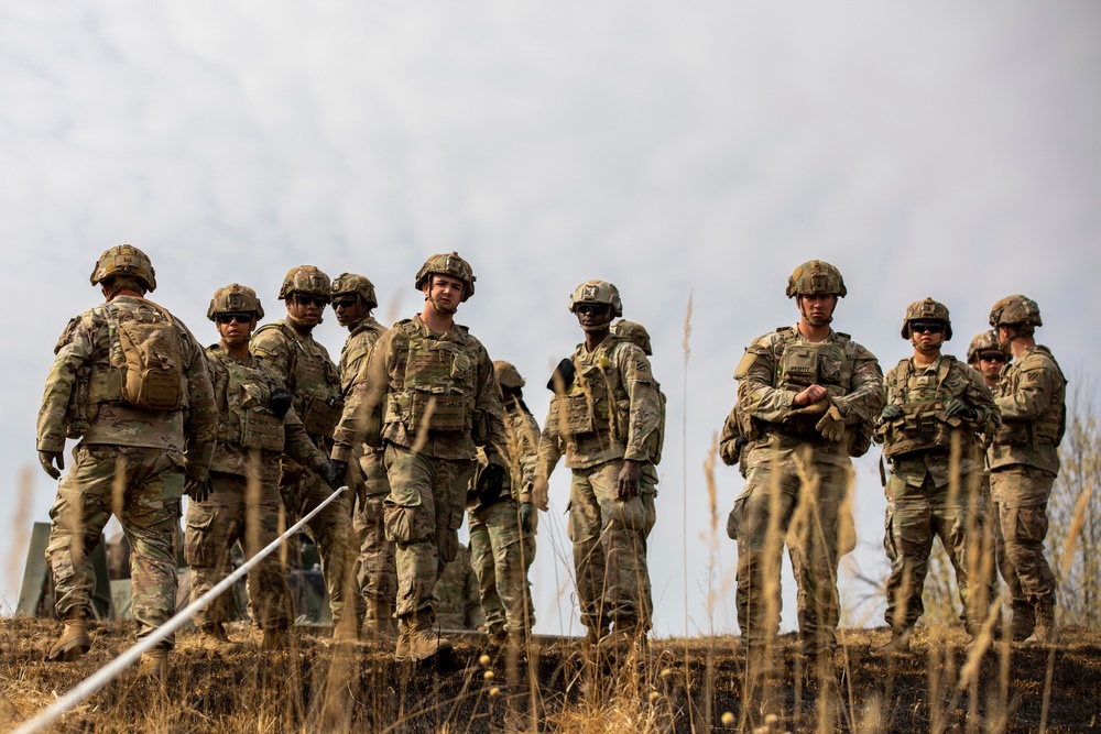 Soldiers survey terrain following dry run of Mine Clearing Line Charge (MiC-LiC)