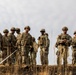 Soldiers survey terrain following dry run of Mine Clearing Line Charge (MiC-LiC)