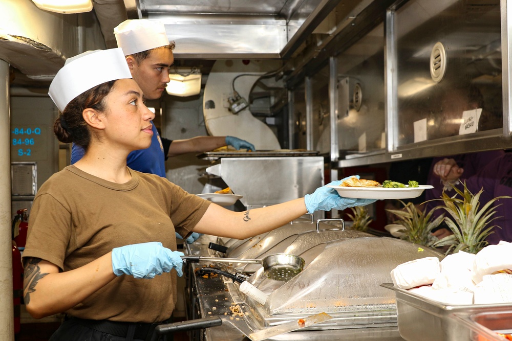 Abraham Lincoln Sailors serve food