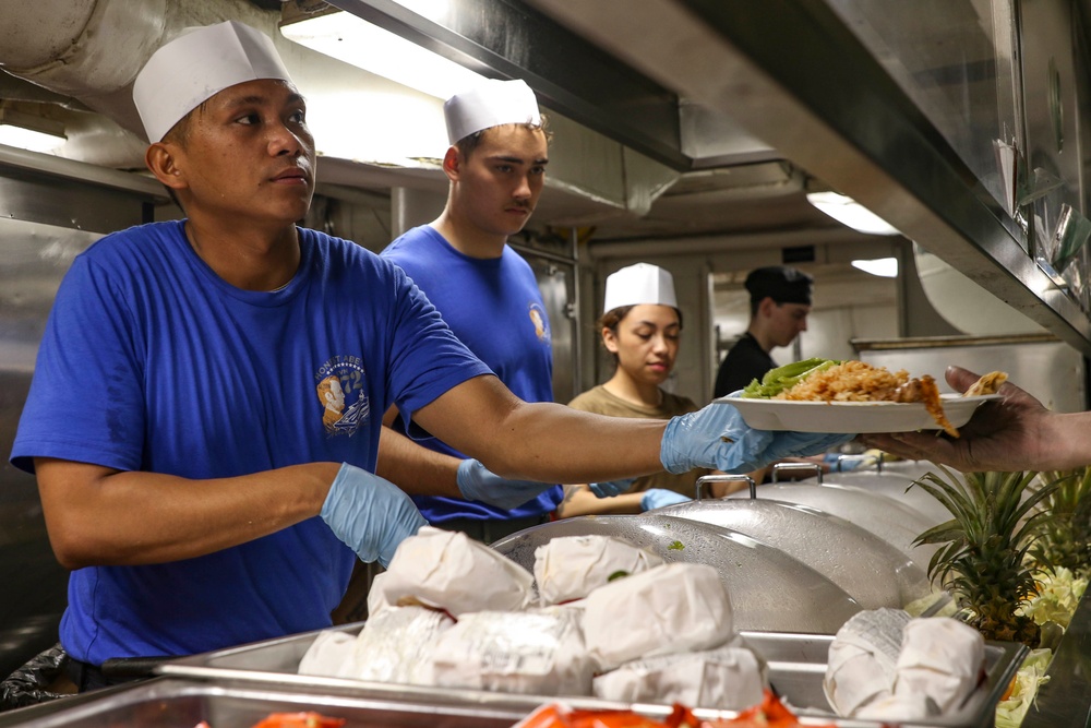 Abraham Lincoln Sailors serve food