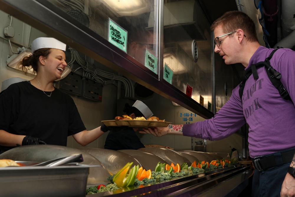 Abraham Lincoln Sailors serve food