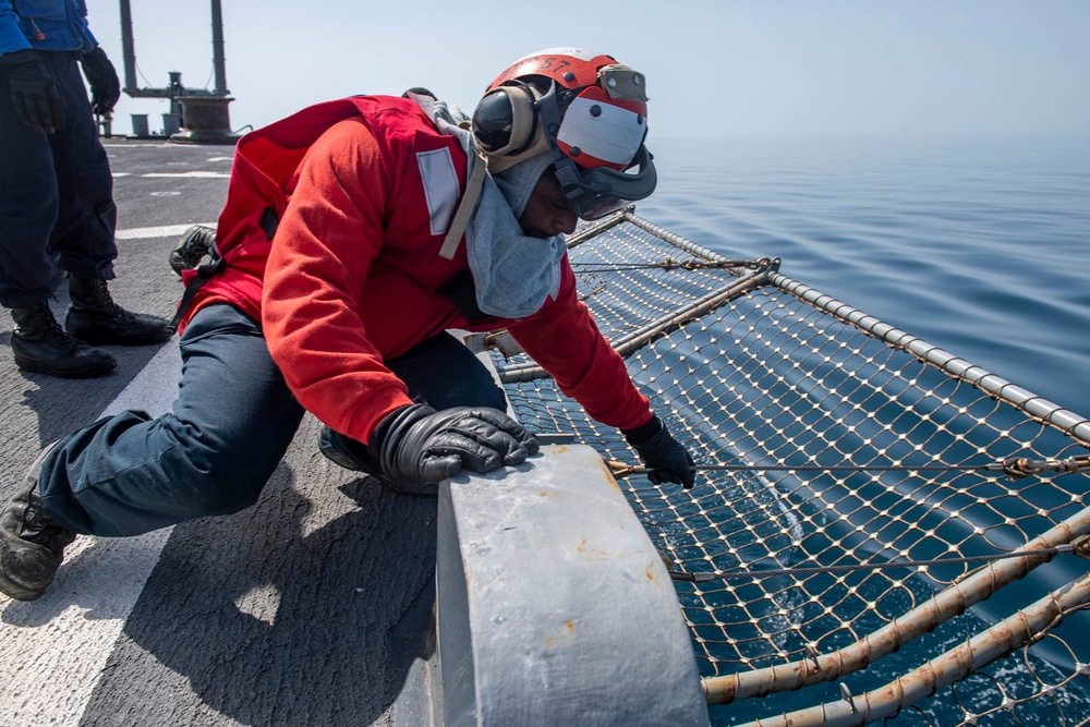 Professional Apprenticeship Career Tract (PACT) Seaman Benjahmin Boie, from Baltimore, Md., lowers safety netting