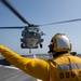 Boatswain’s Mate 3rd Class Isaiah Howard, from Houston, Texas, directs an MH-60S Sea Hawk helicopter