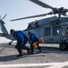 Boatswain’s Mate Seaman Auntarrion Coutee, left, from Houston, Texas, and Boatswain’s Mate 2nd Class Devin Ingle, right, from Bloomfield, Iowa, remove chock and chains from an MH-60S Sea Hawk helicopter