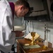 Lt. Fr. Rene Pellessier, from Lafayette, La., assigned to Nimitz-class aircraft carrier USS Dwight D. Eisenhower (CVN 69) prepares for Catholic mass