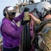 Gas Turbine Systems Technician 3rd Class Demario Spencer, left, from Monroe, La., verifies a fuel sample is clear and bright