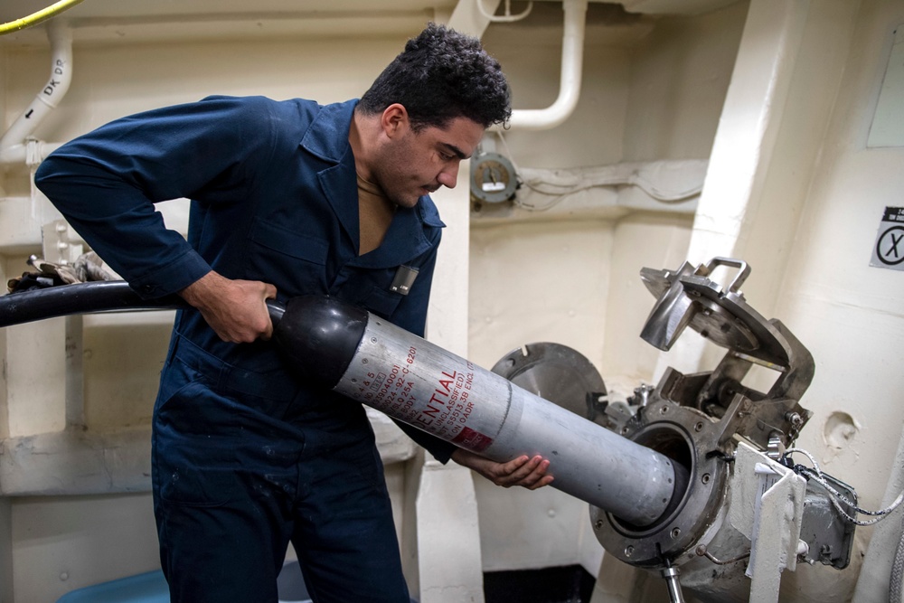 Sonar Technician (Surface) Seaman Jerome Bryant, from Milwaukee, Wis., launches the AN/SLQ-25 Nixie through a port hole