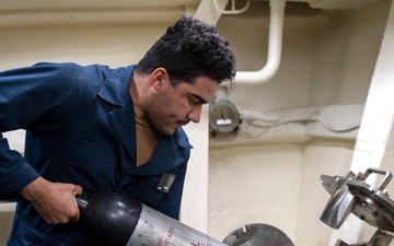 Sonar Technician (Surface) Seaman Jerome Bryant, from Milwaukee, Wis., launches the AN/SLQ-25 Nixie through a port hole
