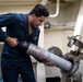 Sonar Technician (Surface) Seaman Jerome Bryant, from Milwaukee, Wis., launches the AN/SLQ-25 Nixie through a port hole