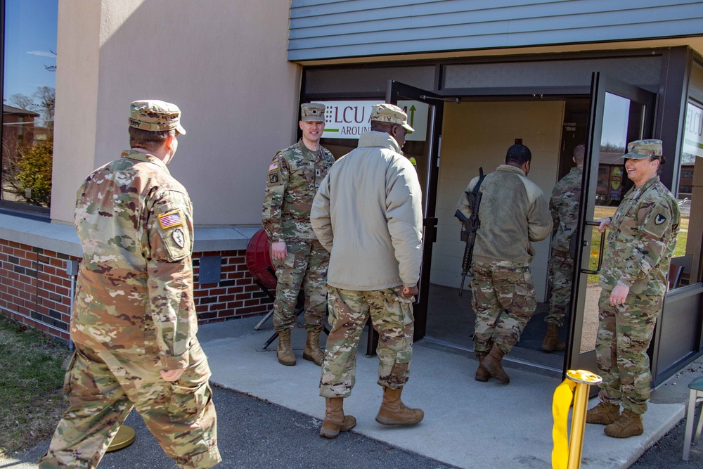 LTC Colestock and CSM Rogers hold open the doors to the dining facility as Soldiers eagerly walk in at the grand opening.