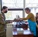 Dining Facility personnel scanning a Soldiers ID for lunch.