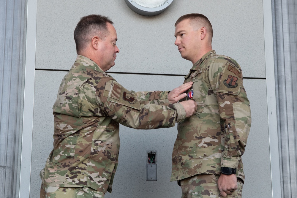 Col. Brian Gunderson, Nevada Air National Guard Director of Staff-Air awards the Nevada Medal of Valor to Tech. Sgt. Cody Sharkey