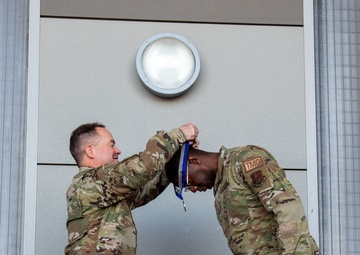 Col. Brian Gunderson, Nevada Air National Guard Director of Staff-Air awards the Maj. Gen. Drennan A. Clark Order of Nevada to Senior Master Sgt. Jordan Clark