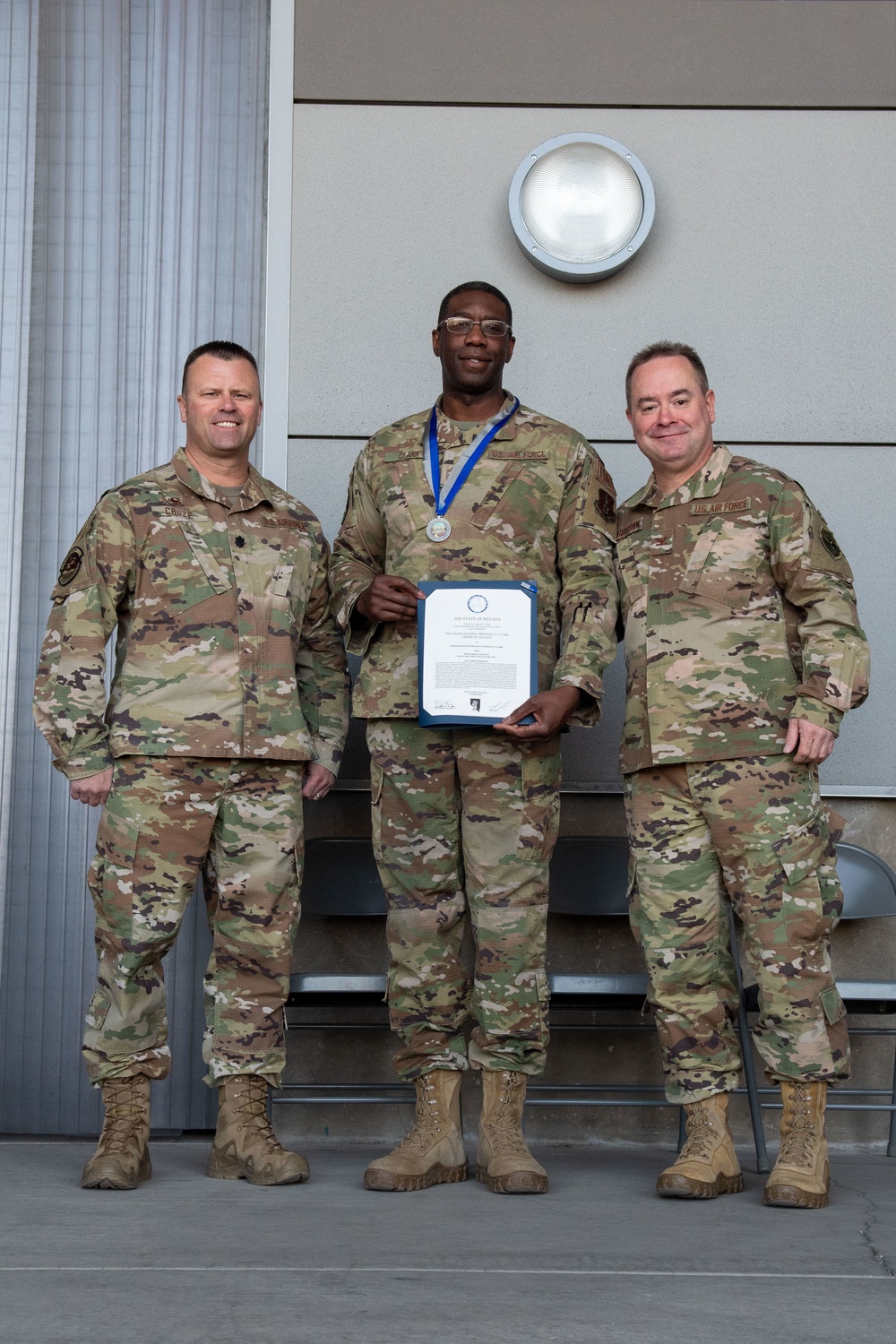 Lt. Col. Shaun Cruze, commander 152nd Logistics Readiness Squadron, Senior Master Sgt. Jordan Clark and Col. Brian Gunderson, Nevada Air National Guard Director of Staff-Air pose after Clark was awarded the Maj. Gen. Drennan A. Clark Order of Nevada