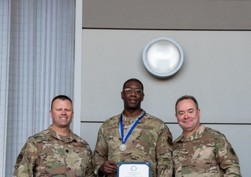 Lt. Col. Shaun Cruze, commander 152nd Logistics Readiness Squadron, Senior Master Sgt. Jordan Clark and Col. Brian Gunderson, Nevada Air National Guard Director of Staff-Air pose after Clark was awarded the Maj. Gen. Drennan A. Clark Order of Nevada