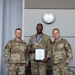 Lt. Col. Shaun Cruze, commander 152nd Logistics Readiness Squadron, Senior Master Sgt. Jordan Clark and Col. Brian Gunderson, Nevada Air National Guard Director of Staff-Air pose after Clark was awarded the Maj. Gen. Drennan A. Clark Order of Nevada