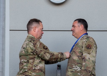 Col. Brian Gunderson, Nevada Air National Guard Director of Staff-Air awards the Maj. Gen. Drennan A. Clark Order of Nevada to Senior Master Sgt. Rommie Brown
