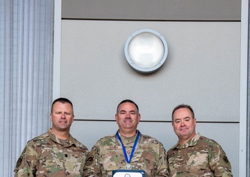 Lt. Col. Shaun Cruze, commander 152nd Logistics Readiness Squadron, Senior Master Sgt. Rommie Brown and Col. Brian Gunderson, Nevada Air National Guard Director of Staff-Air pose after Brown was awarded the Maj. Gen. Drennan A. Clark Order of Nevada Medal