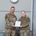 Lt. Col. Shaun Cruze, commander 152nd Logistics Readiness Squadron presents the Air Force Commendation Medal first oak leaf cluster to Master Sgt. Jennifer Cronin