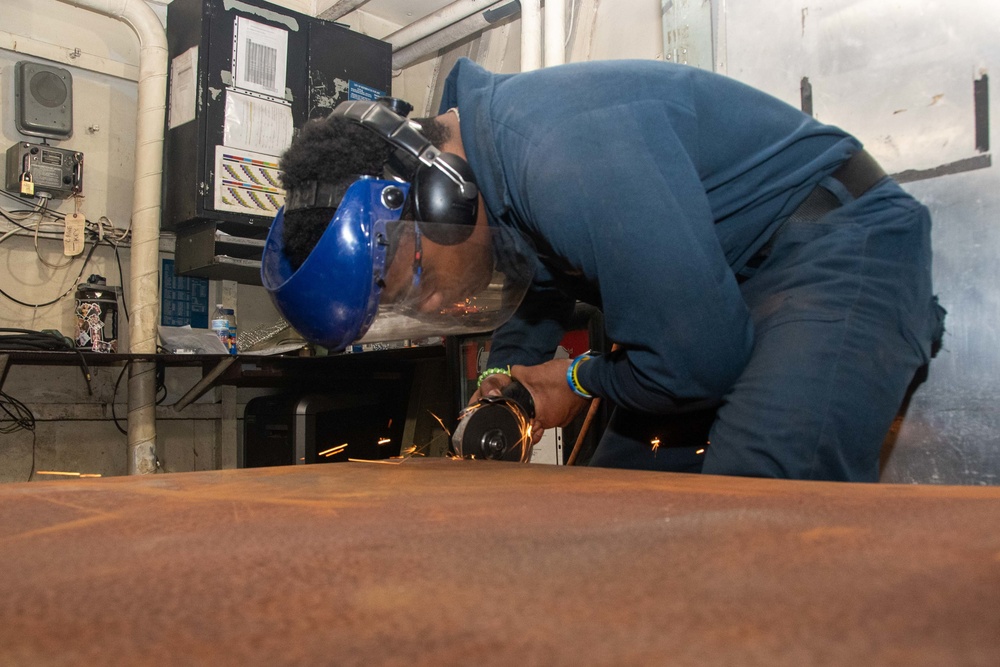 Sailor cuts metal