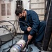 Damage Controlman Fireman Apprentice Michael Resendiz, from Los Angeles, Calif., refills a self-contained breathing apparatus