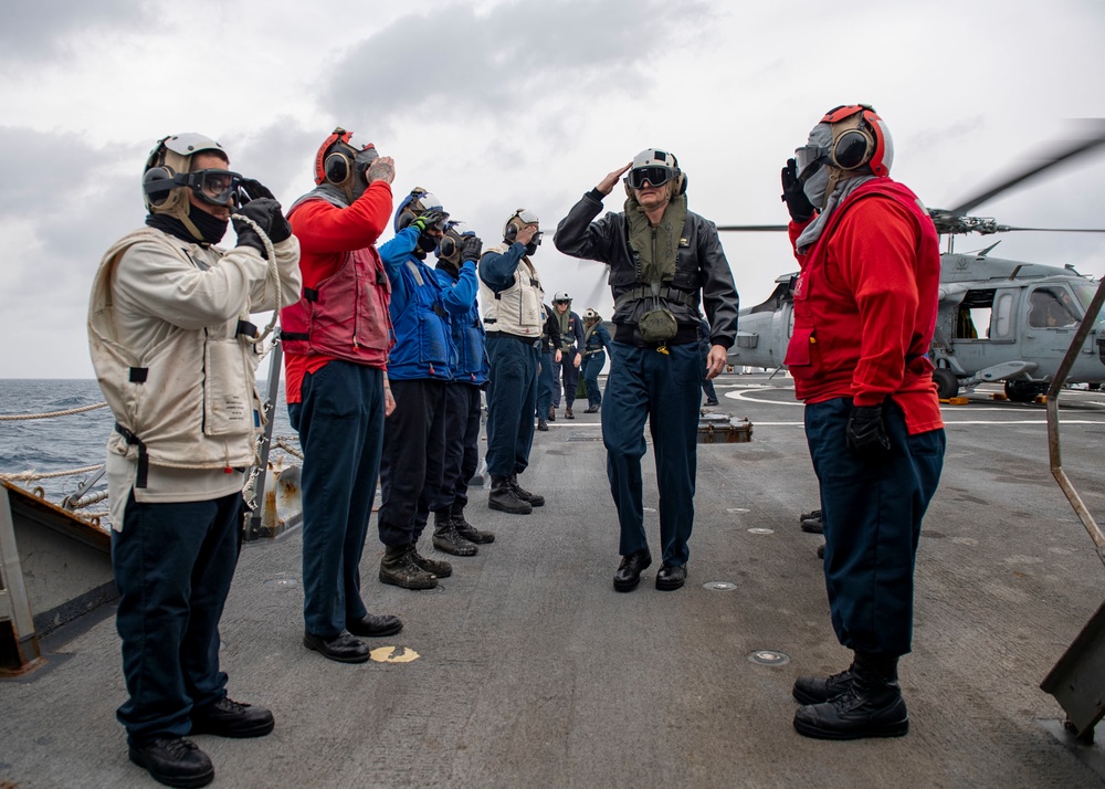 Side boys salute as Rear Adm. Curt Renshaw, commander Carrier Strike Group (CSG) 8, arrives aboard USS Mitscher (DDG 57)