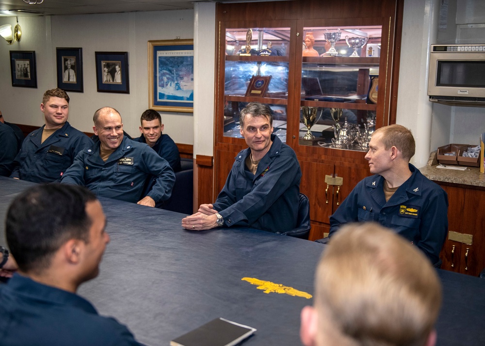 Rear Adm. Curt Renshaw, commander Carrier Strike Group (CSG) 8, addresses the wardroom assigned to USS Mitscher (DDG 57)