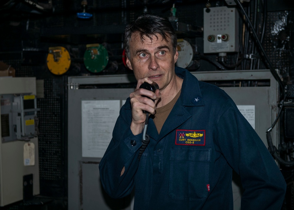 Rear Adm. Curt Renshaw, commander of Carrier Strike Group (CSG) 8, addresses the crew over the 1-MC