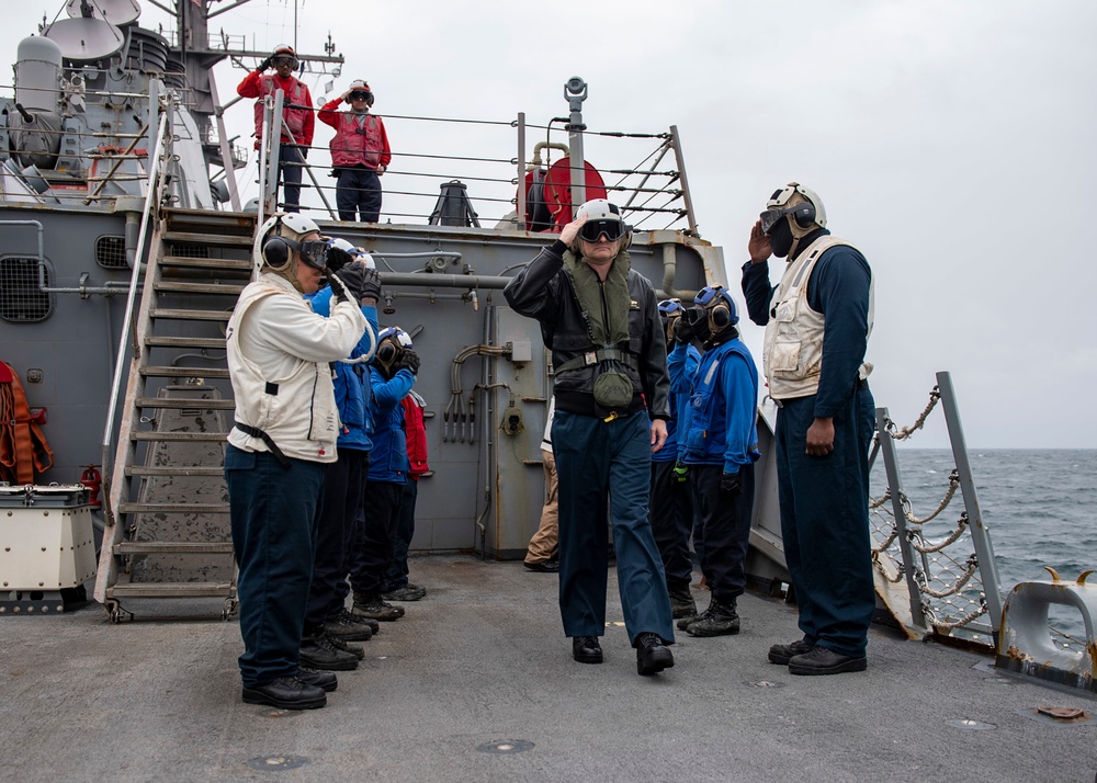 Side boys salute as Rear Adm. Curt Renshaw, commander of Carrier Strike Group (CSG) 8, departs USS Mitscher (DDG 57)