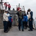 Side boys salute as Rear Adm. Curt Renshaw, commander of Carrier Strike Group (CSG) 8, departs USS Mitscher (DDG 57)