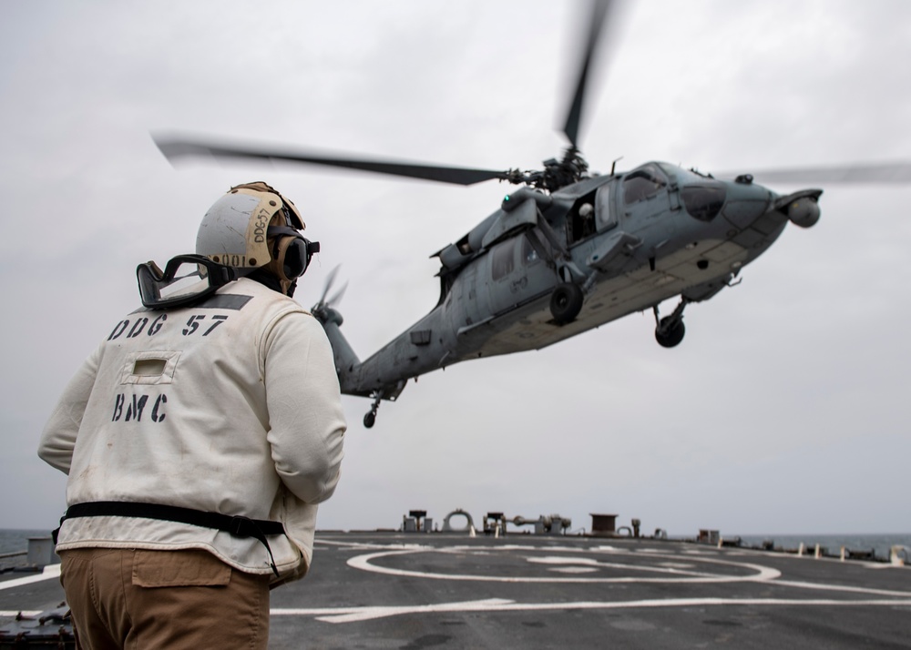 Chief Boatswain’s Mate Anthony Hester, from St. Louis, Mo., stands as a safety observer while an MH-60S Sea Hawk helicopter assigned to the “Dragonslayers” of Helicopter