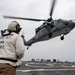 Chief Boatswain’s Mate Anthony Hester, from St. Louis, Mo., stands as a safety observer while an MH-60S Sea Hawk helicopter assigned to the “Dragonslayers” of Helicopter