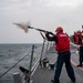 Gunner’s Mate Seaman Tristen Glenn, left, from Lancaster, S.C., assigned to the Arleigh Burke-class guided-missile destroyer USS Mitscher (DDG 57), fires a shot line