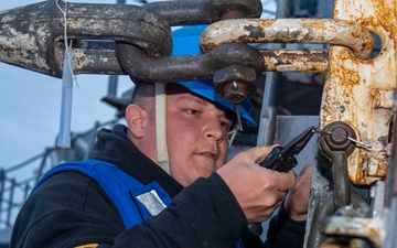 Professional Apprenticeship Career Tract (PACT) Seaman Cullen Patterson, from Cherry Hill, N.J., assigned to the Arleigh Burke-class guided-missile destroyer USS Mitscher (DDG 57), removes a pin from a pad eye winch
