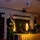 Commander, 7th Fleet Attends Surface Warfare Officer's Ball A formal banquet or gala event featuring a uniformed military officer speaking at a podium with a microphone. The venue is decorated with white balloon arches and Asian-themed lanterns, suggesting a formal military or organizational dinner. Several attendees are seated at a head table in formal attire.