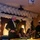 Commander, 7th Fleet Attends Surface Warfare Officer's Ball A formal military or naval banquet/gala event is taking place in a decorated hall. A senior naval officer in dress uniform with medals is raising a wine glass to make a toast while holding a microphone. The venue is decorated with a large white balloon arch and the attendees are dressed in formal attire.