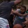The Harry S. Truman Carrier Strike Group is on a scheduled deployment in the U.S. Sixth Fleet area of operations in support of naval operations to maintain maritime stability and security. Two men are engaged in an intense basketball game, with one player driving toward the basket while being defended by another. A crowd of spectators watches from the sidelines in what appears to be an indoor gymnasium or recreational facility. The action is captured up close, emphasizing the physical contest between the two players.