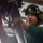 The Harry S. Truman Carrier Strike Group is on a scheduled deployment in the U.S. Sixth Fleet area of operations in support of naval operations to maintain maritime stability and security. A male technician or military personnel wearing a green helmet with communication headset and protective goggles is working on mechanical equipment overhead. He is dressed in a green t-shirt and appears to be in an industrial or military hangar/bay environment. The image is taken from a low angle, emphasizing the work being performed on what appears to be aircraft or heavy equipment components.