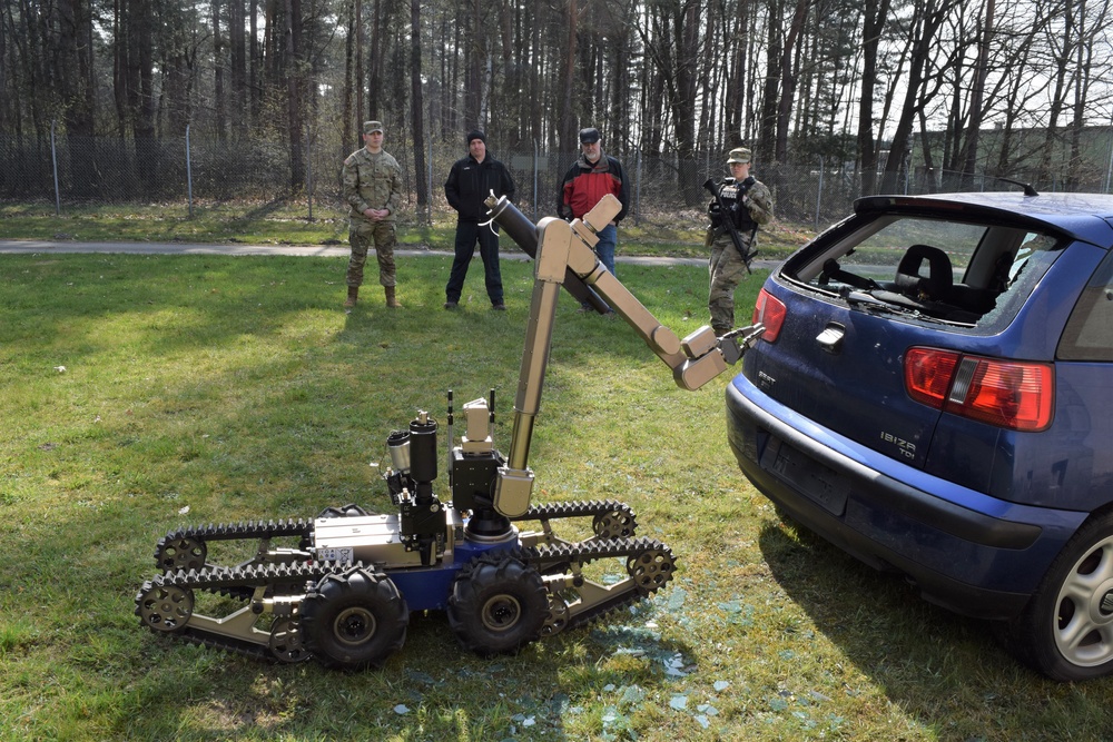 Remote control robot attempts to open vehicle with mock bomb