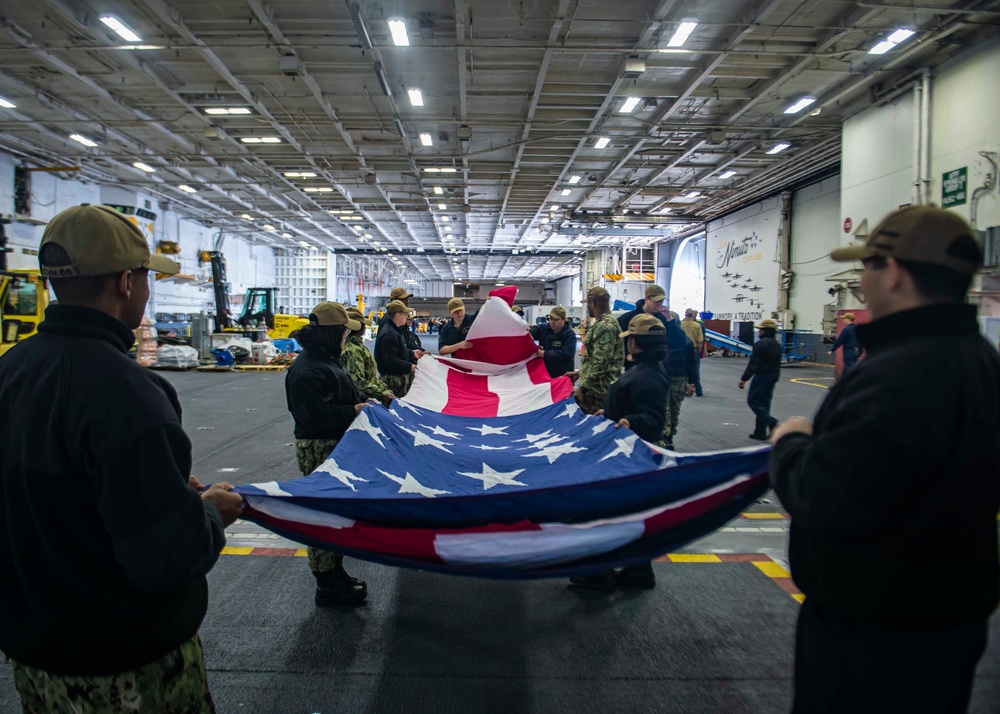 Sailors Fold A Ceremonial Flag