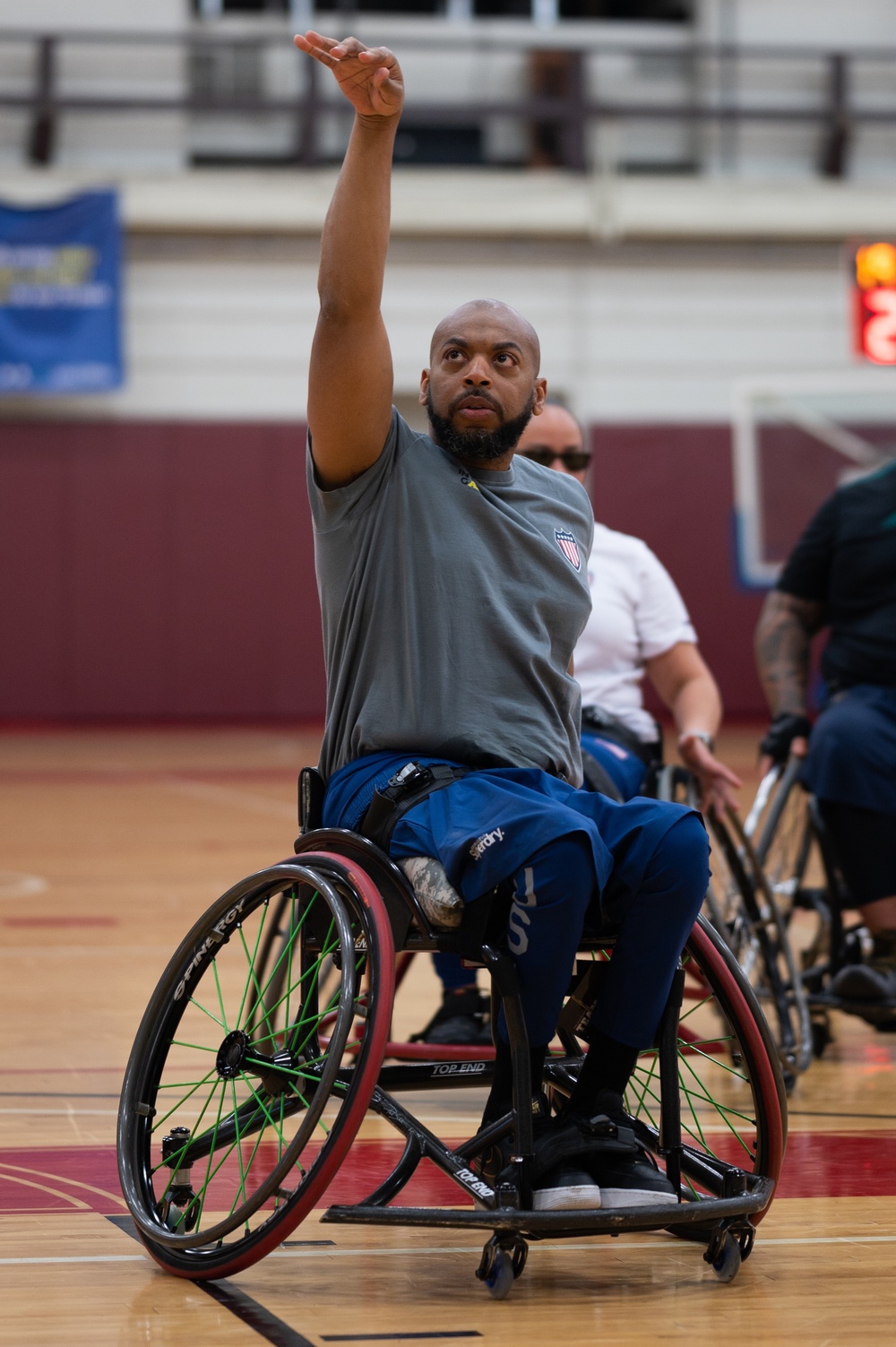 Retired U.S. Army Spc. Brent Garlic shoots a basketball