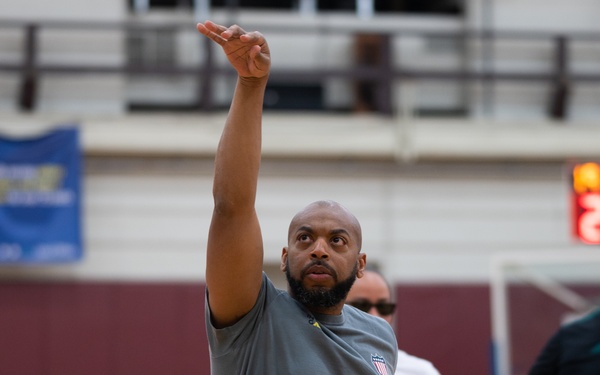 Retired U.S. Army Spc. Brent Garlic shoots a basketball