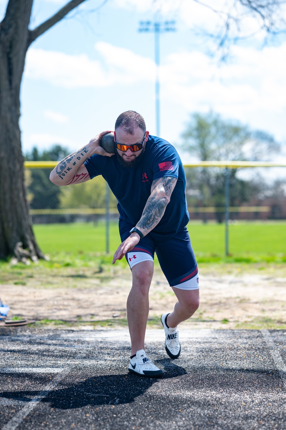 Retired U.S. Army Staff Sgt Ross Alewine throws a shot putt