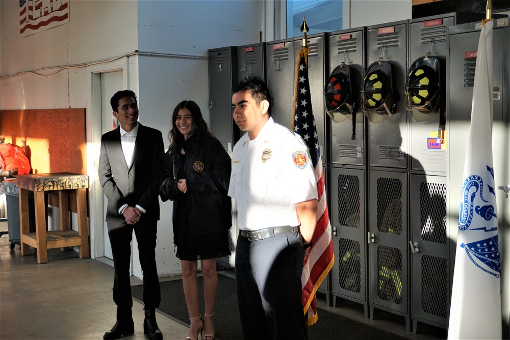 Catherine Velasco pins the second set of bugles, the symbol of leadership and communication, on her father’s collar at the Tooele Army Depot (TEAD) North Fire Department on Apr 07, 2022 as part of the pinning ceremony.