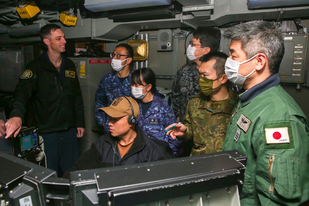 Abraham Lincoln Sailors and JMSDF military leaders observe a sonar module