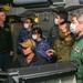 Abraham Lincoln Sailors and JMSDF military leaders observe a sonar module